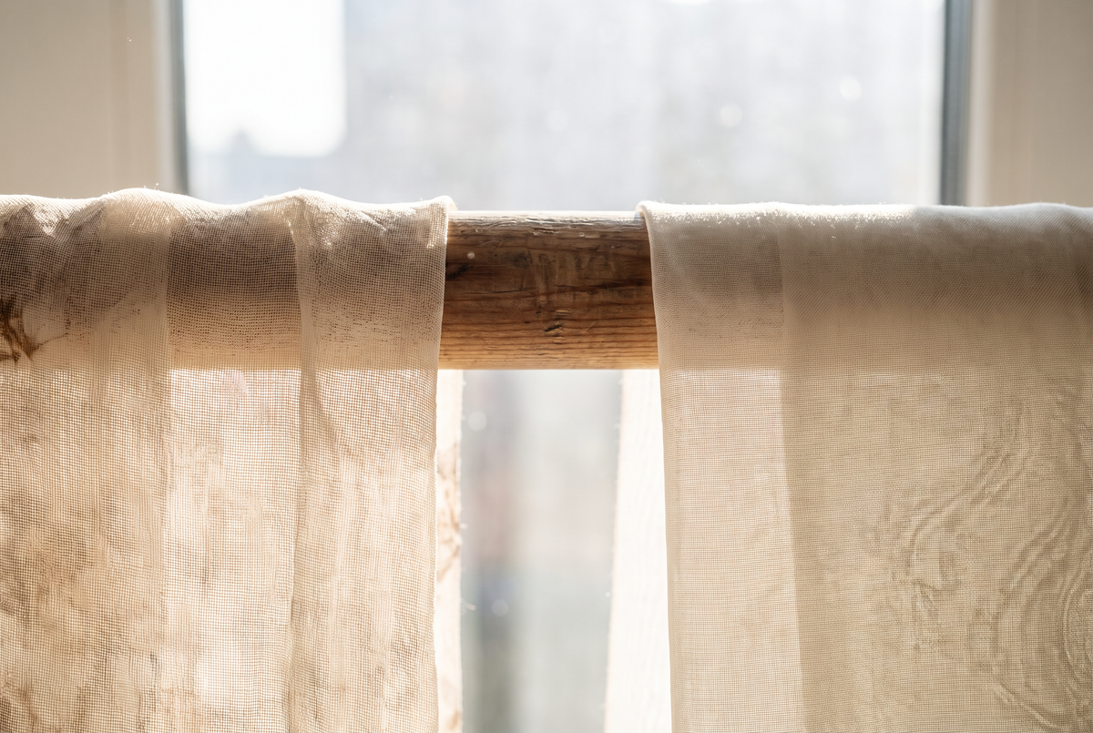 Chiffon and voile fabrics draped side by side in window light
